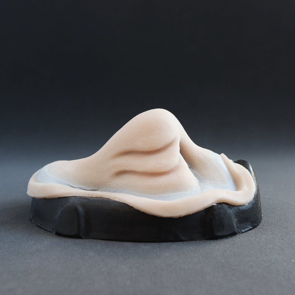 Manta Nose - Silicone makeup prosthetic in vanilla shade on a black surface