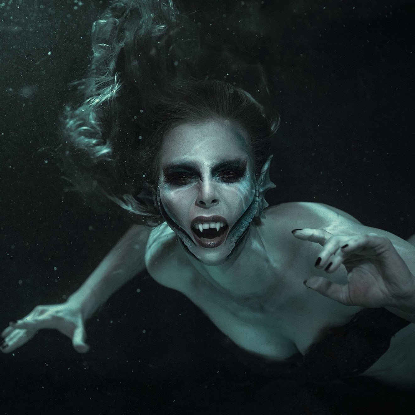 Blue mermaid wearing mermaid gills