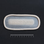 Missit Me Dominus Carving (The Lord Has Sent Me) - Silicone prosthetic in vanilla shade on a black surface with a ruler