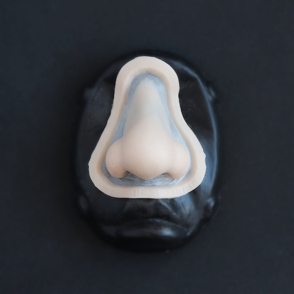 Nordic Troll Nose - Silicone makeup prosthetic in vanilla shade on a black surface