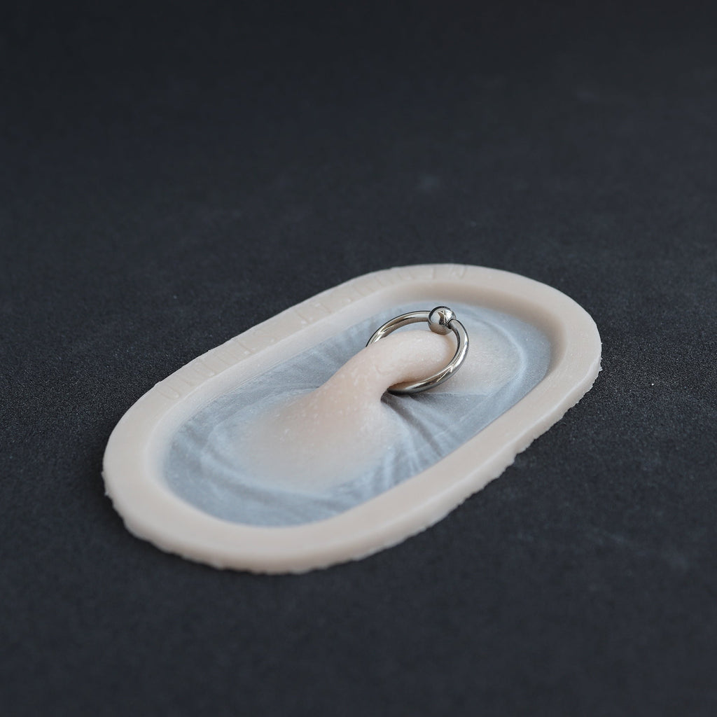 Nose Bridge - Silicone makeup prosthetic in vanilla shade on a black surface