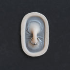 Nose Bridge - Silicone makeup prosthetic in vanilla shade on a black surface