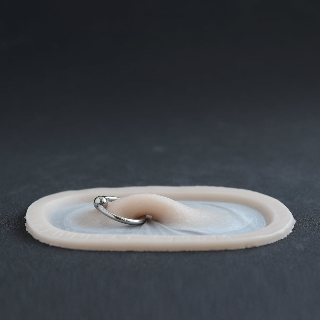 Nose Bridge - Silicone makeup prosthetic in vanilla shade on a black surface