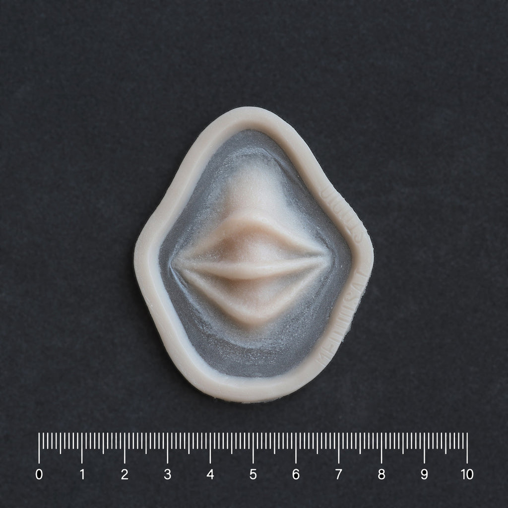 Nose Bridge Ridges - Silicone makeup prosthetic in vanilla shade on a black surface with a ruler