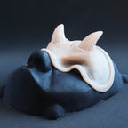 Oni Brow silicone prosthetic in vanilla shade on a black surface at an angle