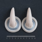 Oni Horns - Silicone makeup prosthetic in vanilla shade on a black surface with a ruler