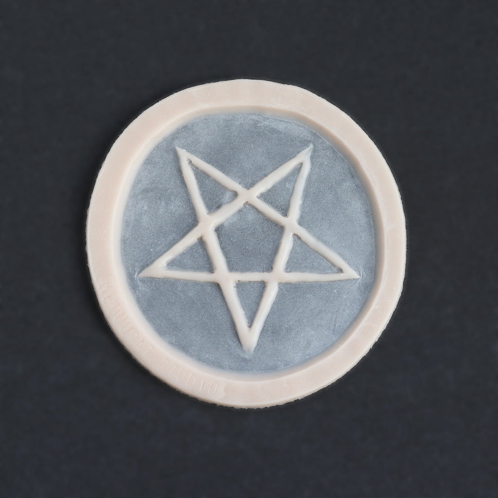 Pentagram Scarification - Silicone makeup prosthetic in vanilla shade on a black surface