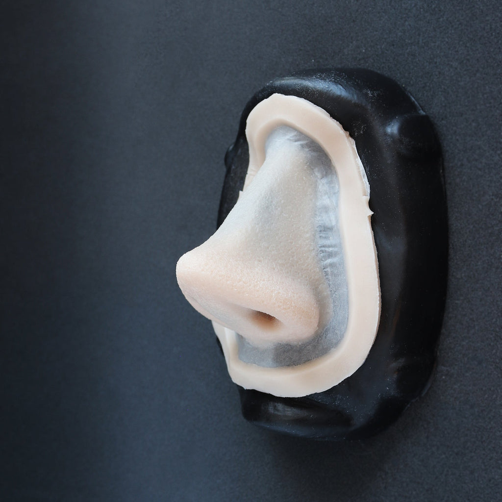 Piglet Nose - Silicone makeup prosthetic in vanilla shade on a black surface