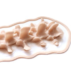 Protruding Spine (Lifesize) - Silicone makeup prosthetic in vanilla shade on a white surface