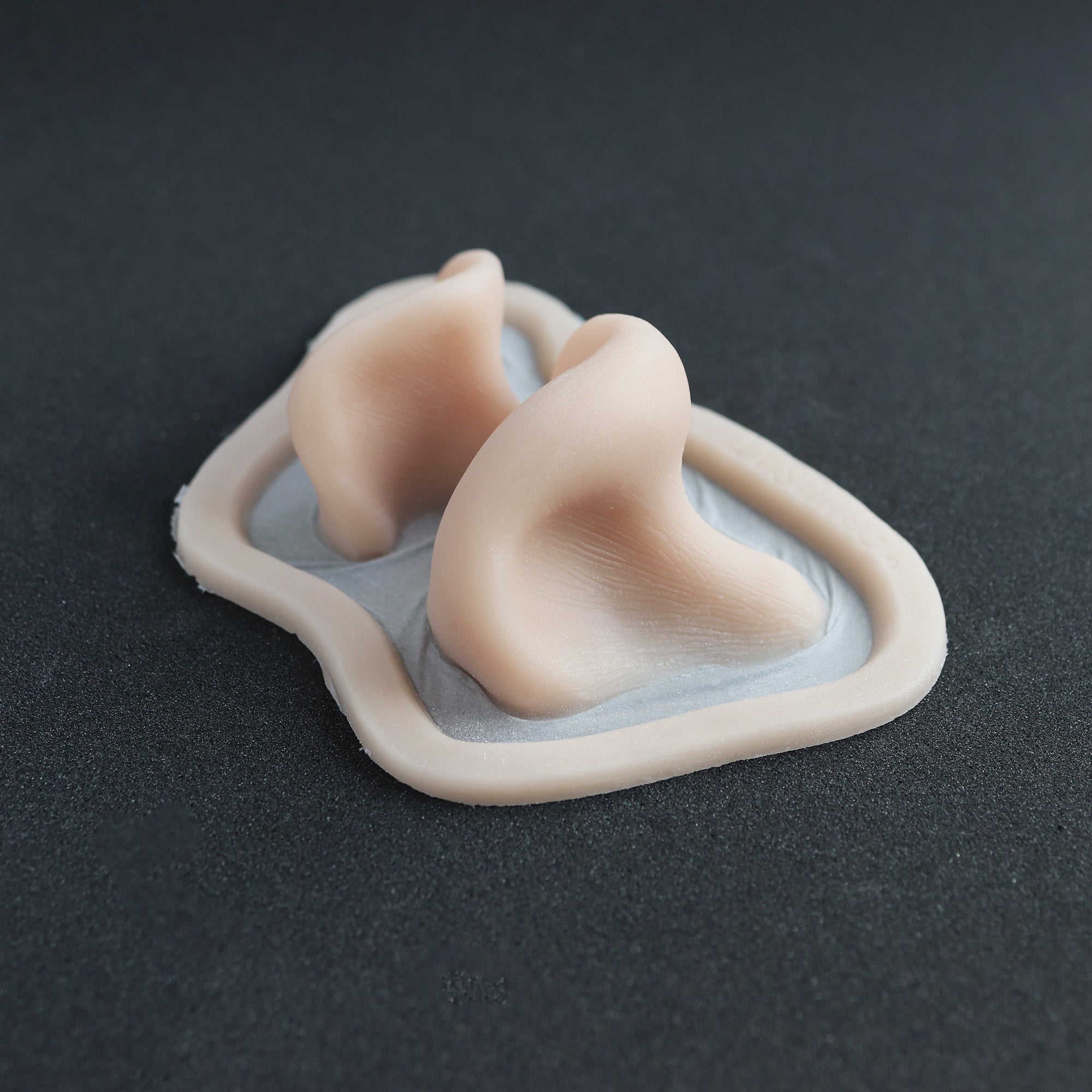 Resinous Polypore Mushrooms - Silicone makeup prosthetic in vanilla shade on a black surface