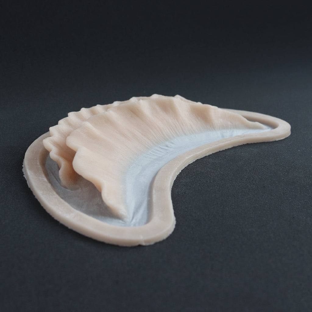 Ruffle Gills (Pair) - Silicone makeup prosthetic in vanilla shade on a black surface