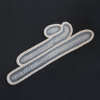 Scarification Strips - Silicone makeup prosthetic in vanilla shade on a black surface