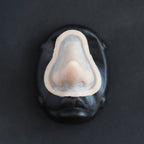 Short Pointy Nose - Silicone makeup prosthetic in vanilla shade on a black surface
