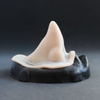 Short Pointy Nose - Silicone makeup prosthetic in vanilla shade on a black surface