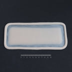 Long Silicone Patch - Silicone makeup prosthetic in vanilla shade on a black surface with a ruler