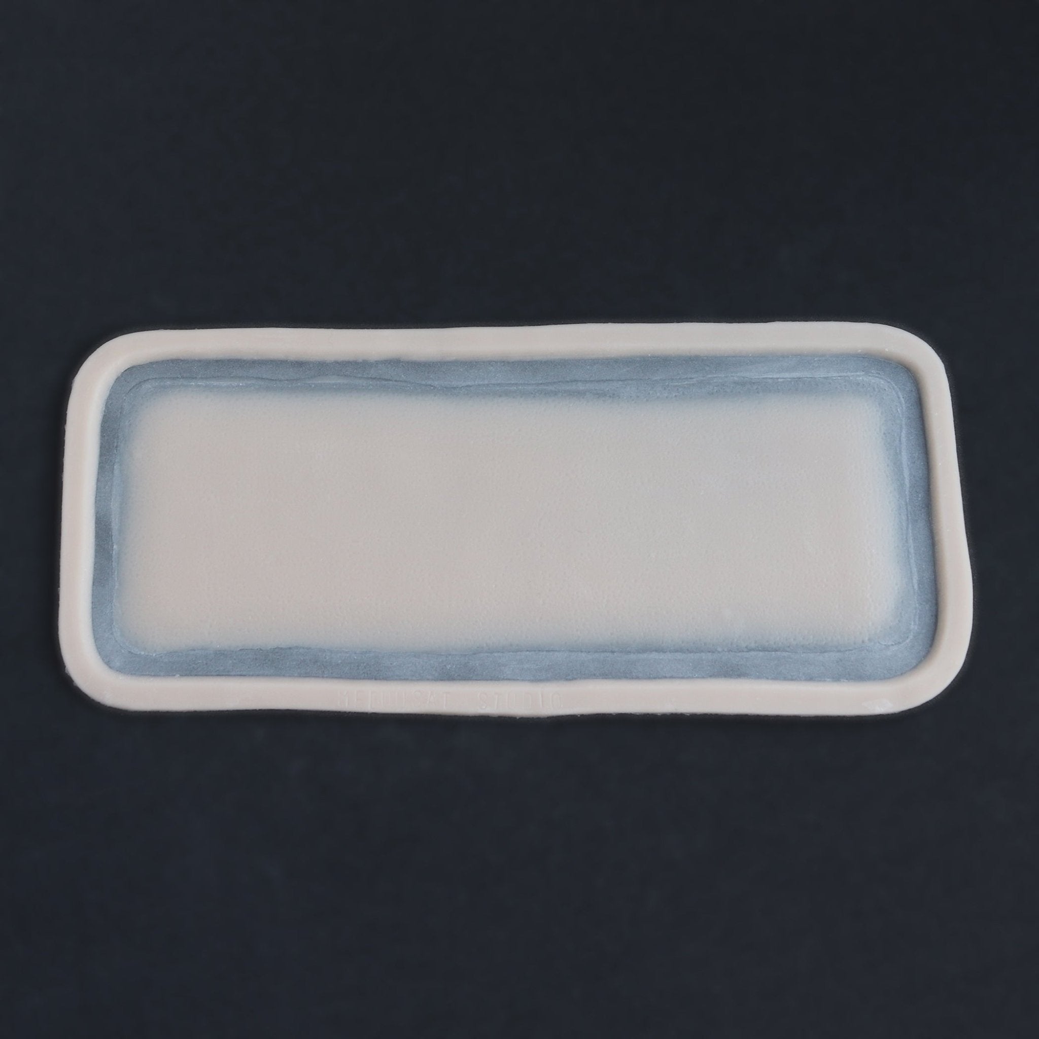 Long Silicone Patch - Silicone makeup prosthetic in vanilla shade on a black surface