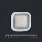 Mini Silicone Patch - Silicone makeup prosthetic in vanilla shade on a black surface with a ruler