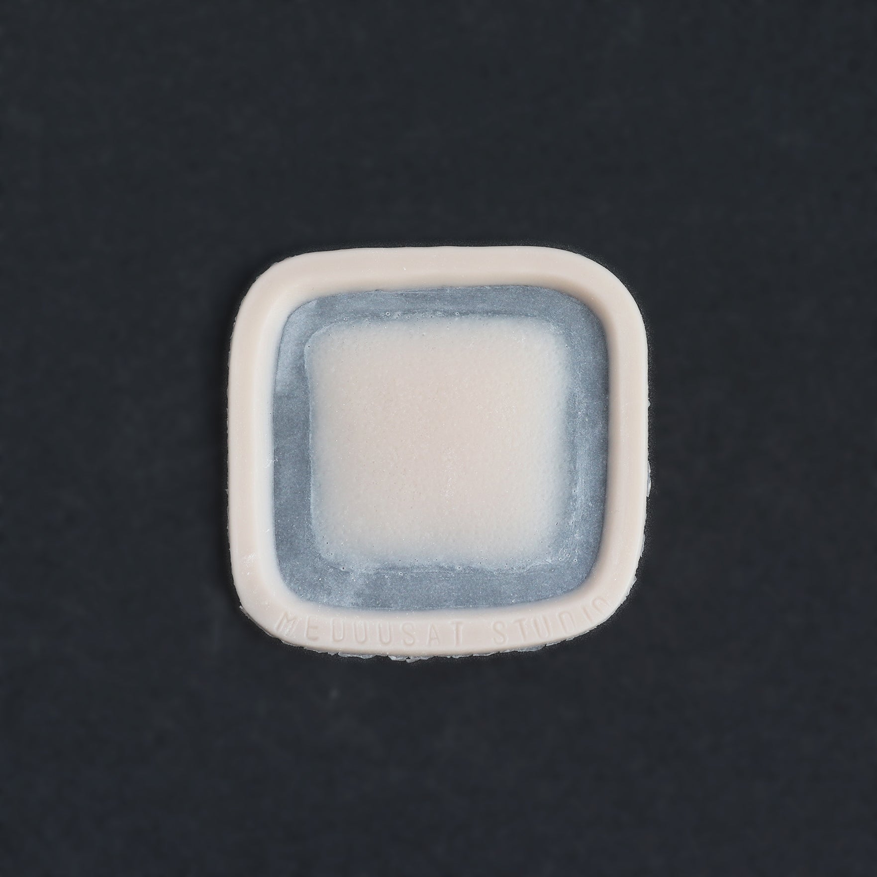 Mini Silicone Patch - Silicone makeup prosthetic in vanilla shade on a black surface