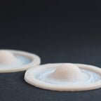 Single Subdermal Horns (Pair) - Silicone makeup prosthetic in vanilla shade on a black surface
