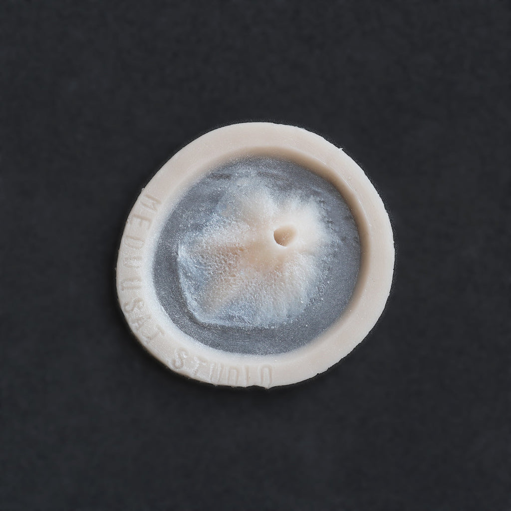 Skin Pocket 2 - Silicone makeup prosthetic in vanilla shade on a black surface