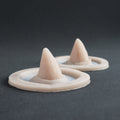 Small Devil Horns (Pair) - Silicone makeup prosthetic in vanilla shade on a black surface