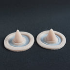 Small Devil Horns (Pair) - Silicone makeup prosthetic in vanilla shade on a black surface