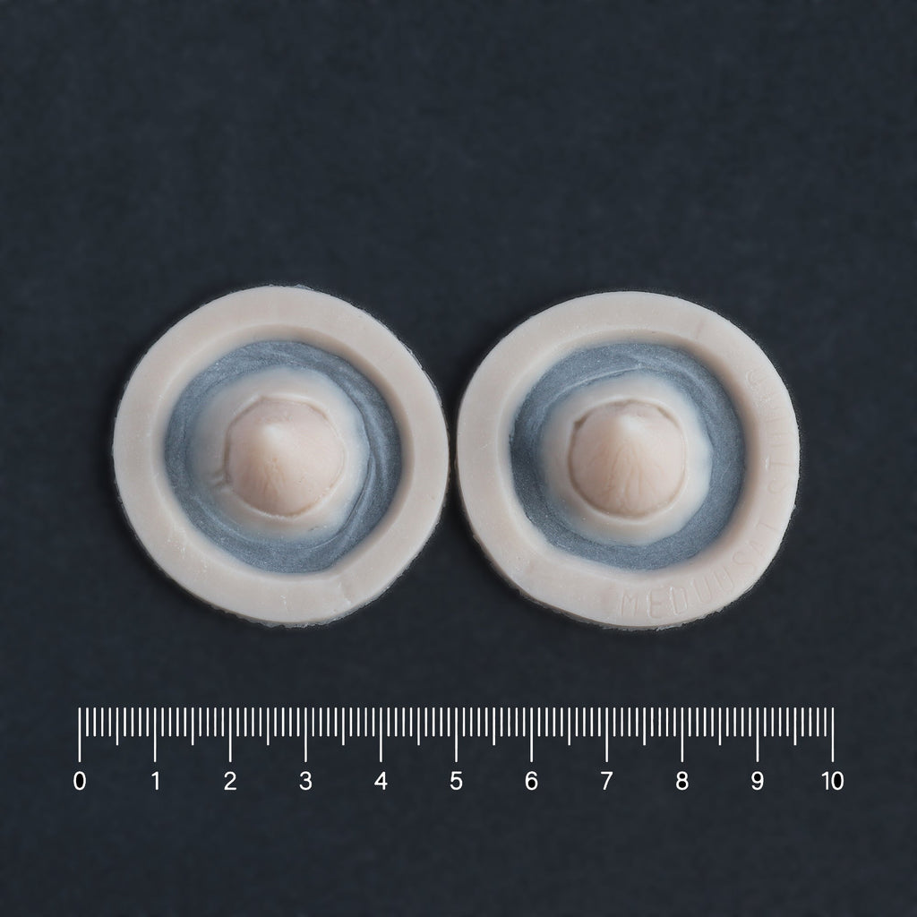 Small Devil Horns (Pair) - Silicone makeup prosthetic in vanilla shade on a black surface with a ruler