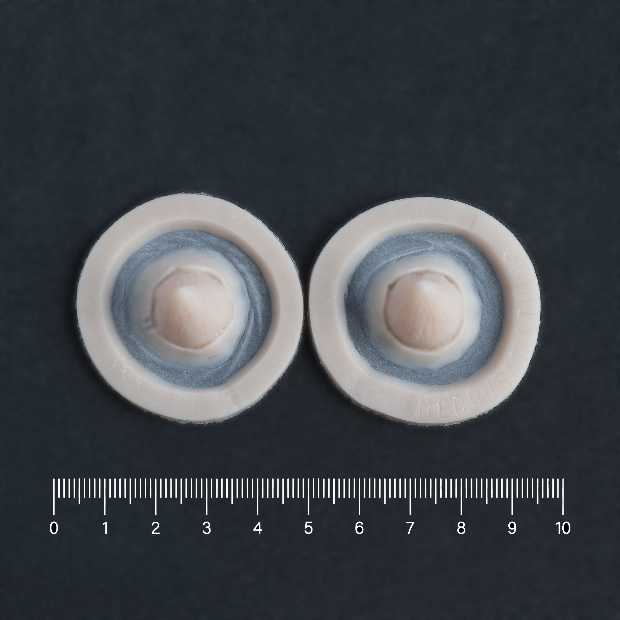 Small Devil Horns (Pair) - Silicone makeup prosthetic in vanilla shade on a black surface with a ruler