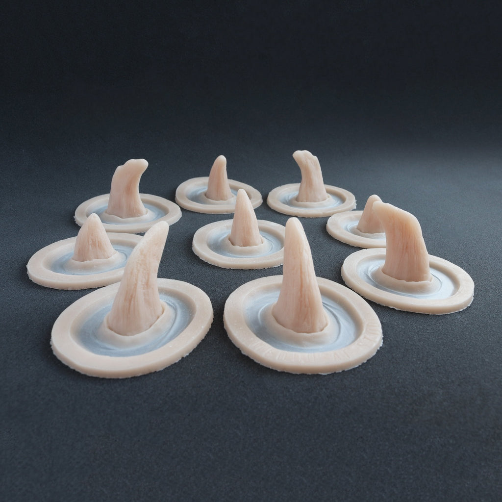 Small Horns Set - Silicone makeup prosthetic in vanilla shade on a black surface
