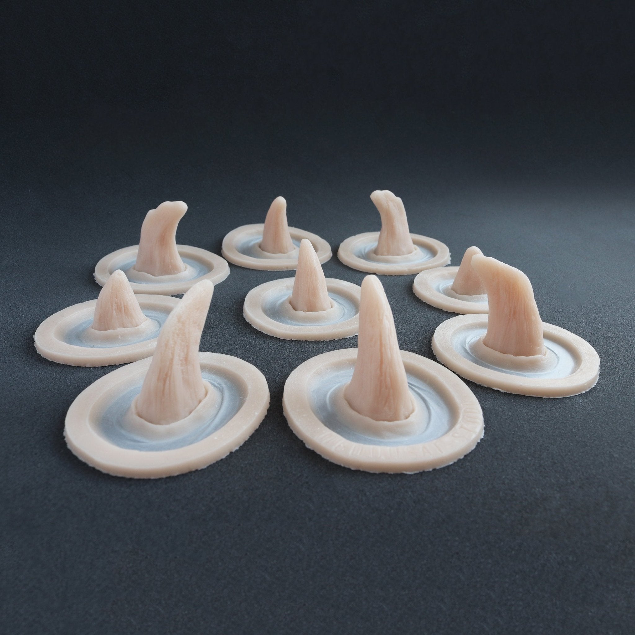 Small Horns Set - Silicone makeup prosthetic in vanilla shade on a black surface