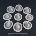 Small Horns Set - Silicone makeup prosthetic in vanilla shade on a black surface with a ruler