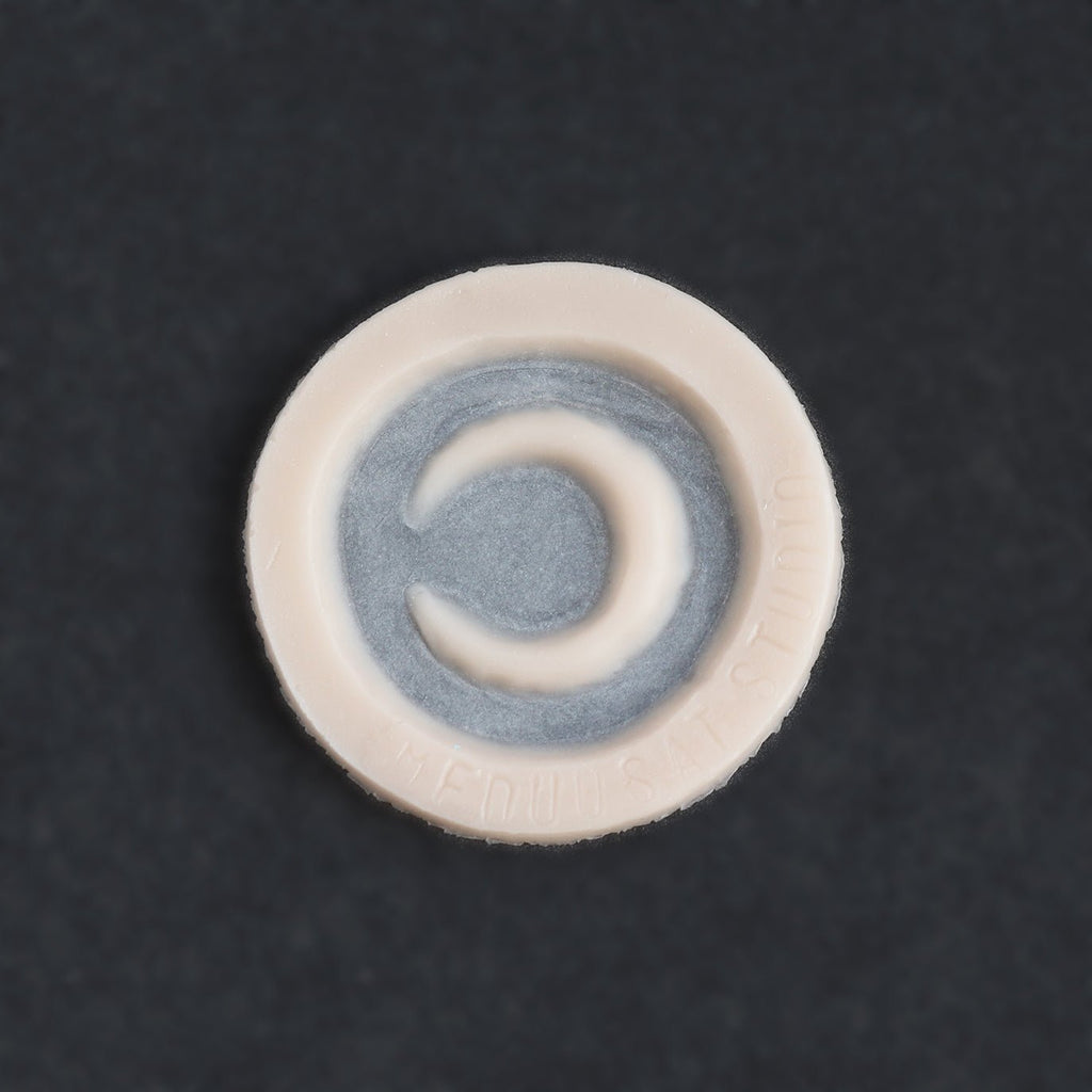 Small Moon - Silicone makeup prosthetic in vanilla shade on a black surface