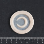 Small Moon - Silicone makeup prosthetic in vanilla shade on a black surface with a ruler