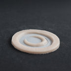 Small Moon - Silicone makeup prosthetic in vanilla shade on a black surface