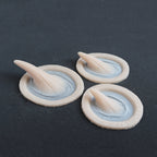 Small Vertical Horns (Pair) - Silicone makeup prosthetic in vanilla shade on a black surface