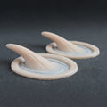 Small Vertical Horns (Pair) - Silicone makeup prosthetic in vanilla shade on a black surface