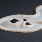 Spider Eyes - Silicone makeup prosthetic in vanilla shade on a black surface