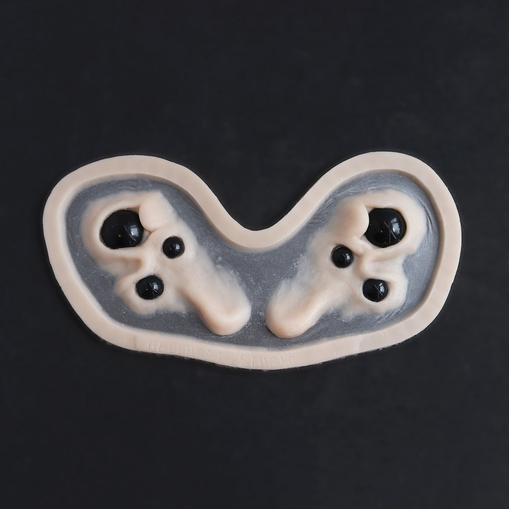 Spider Eyes - Silicone makeup prosthetic in vanilla shade on a black surface