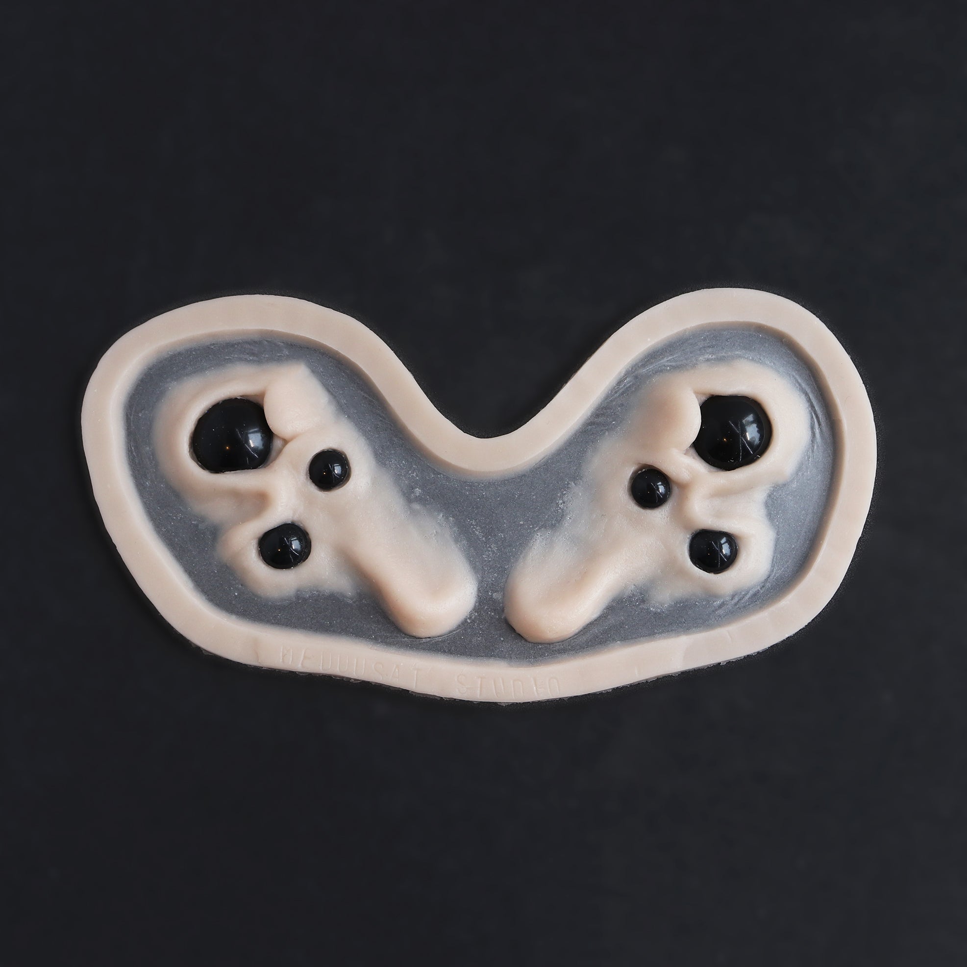 Spider Eyes - Silicone makeup prosthetic in vanilla shade on a black surface