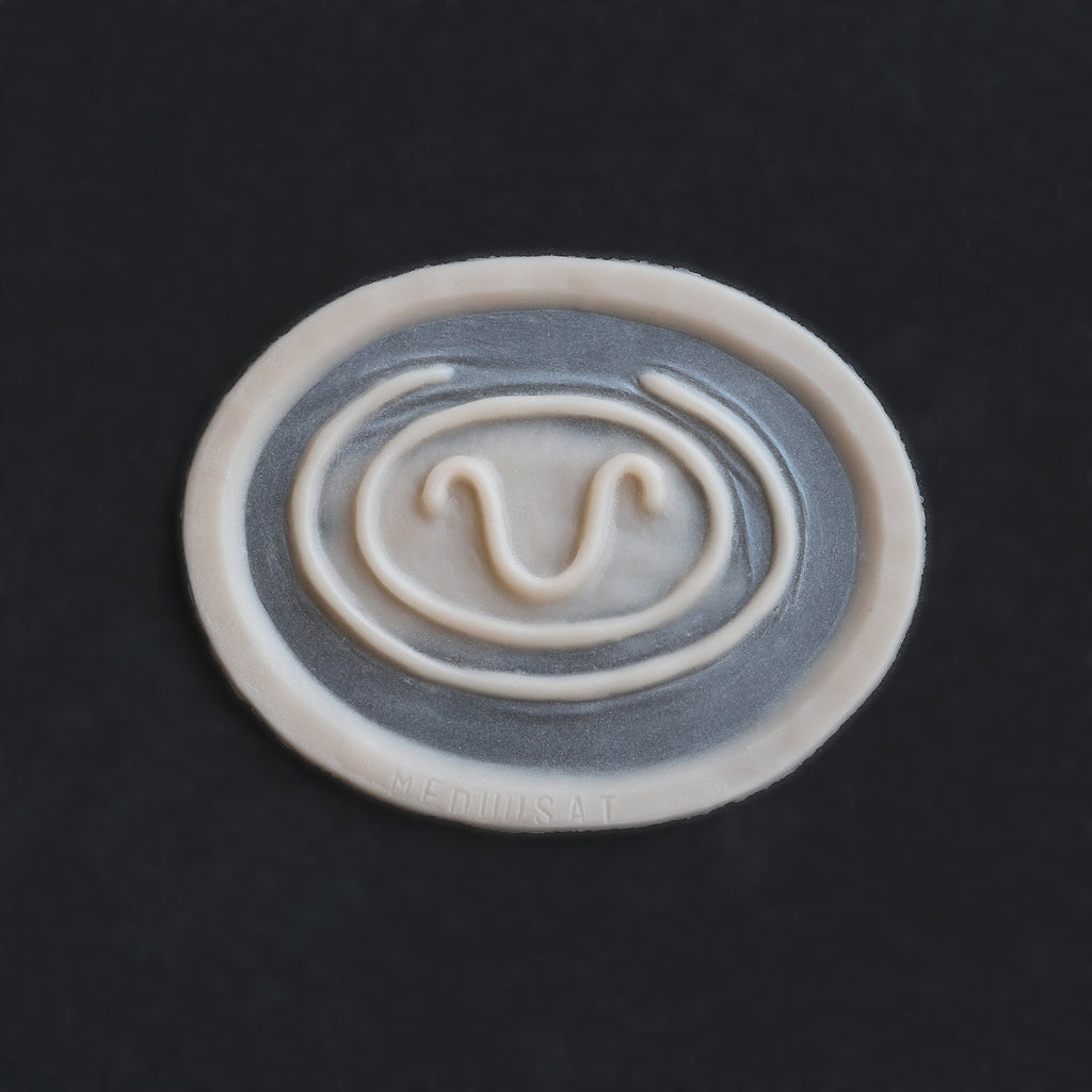 Stargate Goa'uld Mark - Silicone makeup prosthetic in vanilla shade on a black surface