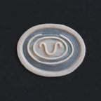 Stargate Goa'uld Mark - Silicone makeup prosthetic in vanilla shade on a black surface