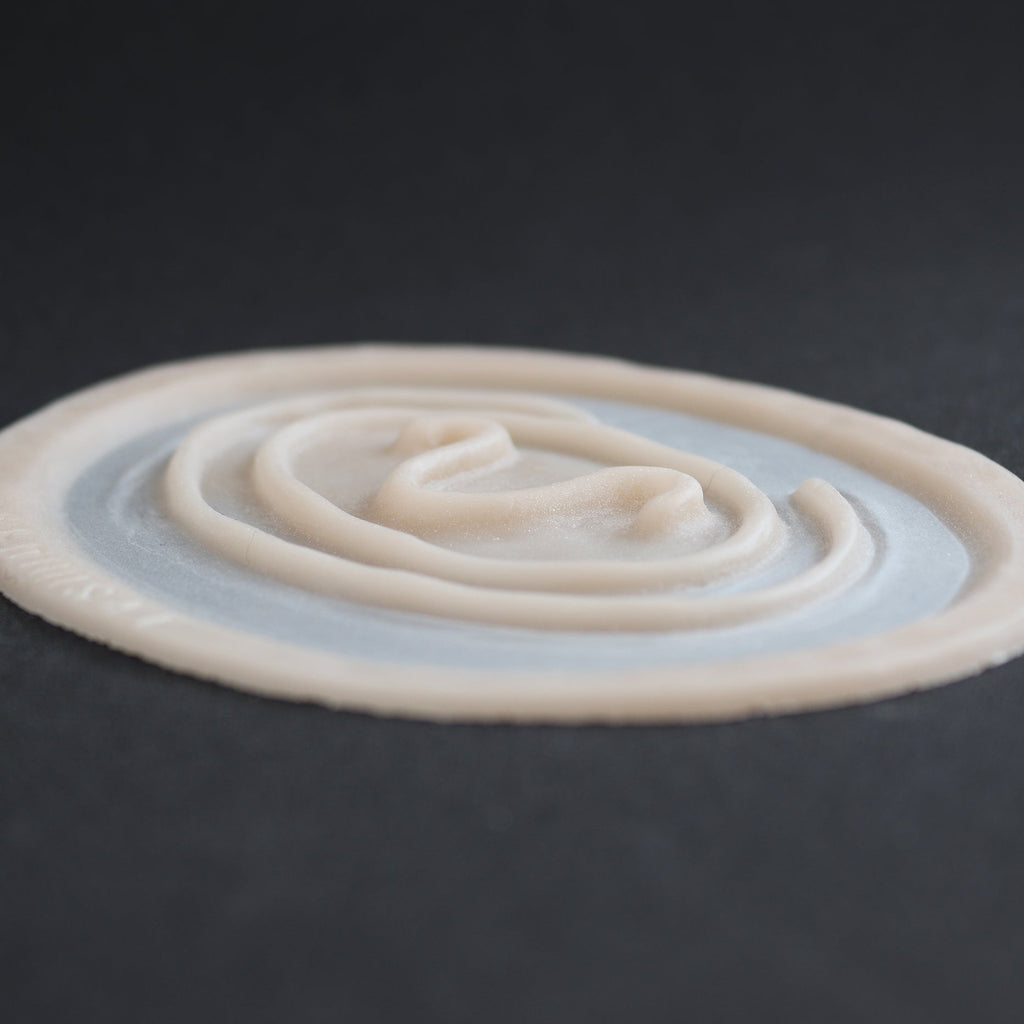 Stargate Goa'uld Mark - Silicone makeup prosthetic in vanilla shade on a black surface