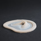 Stretched Piercing - Silicone makeup prosthetic in vanilla shade on a black surface