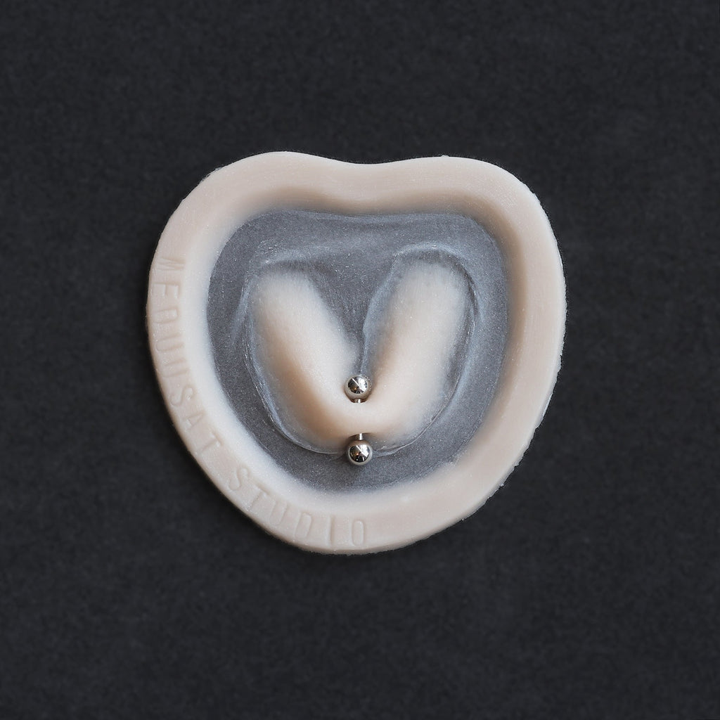 Stretched Piercing - Silicone makeup prosthetic in vanilla shade on a black surface