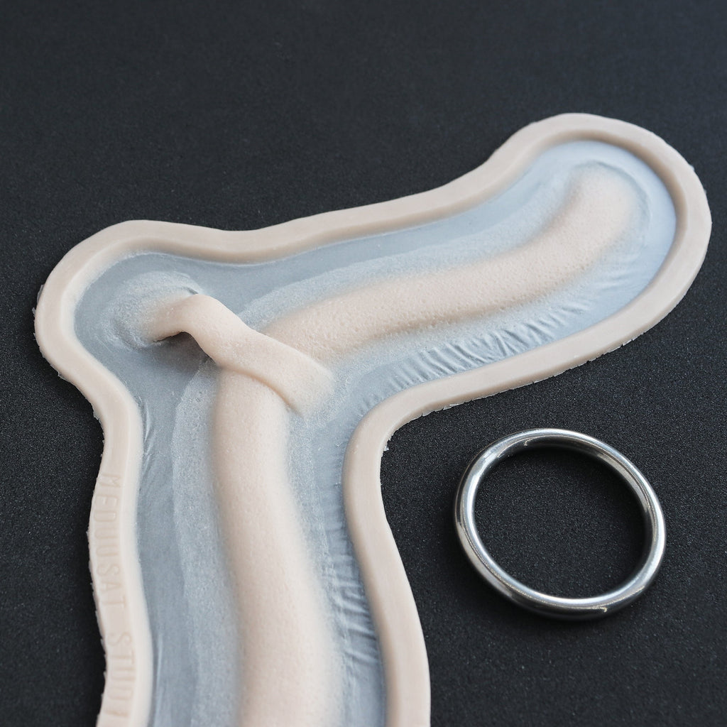 Subdermal Choker - Silicone makeup prosthetic in vanilla shade on a black surface