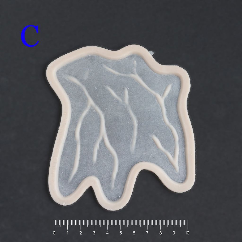 Superficial Cranial Veins C - Silicone makeup prosthetic in vanilla shade on a black surface with a ruler