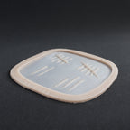 Tally Marks - Silicone makeup prosthetic in vanilla shade on a black surface