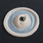 Third Eye - Silicone makeup prosthetic in vanilla shade on a black surface