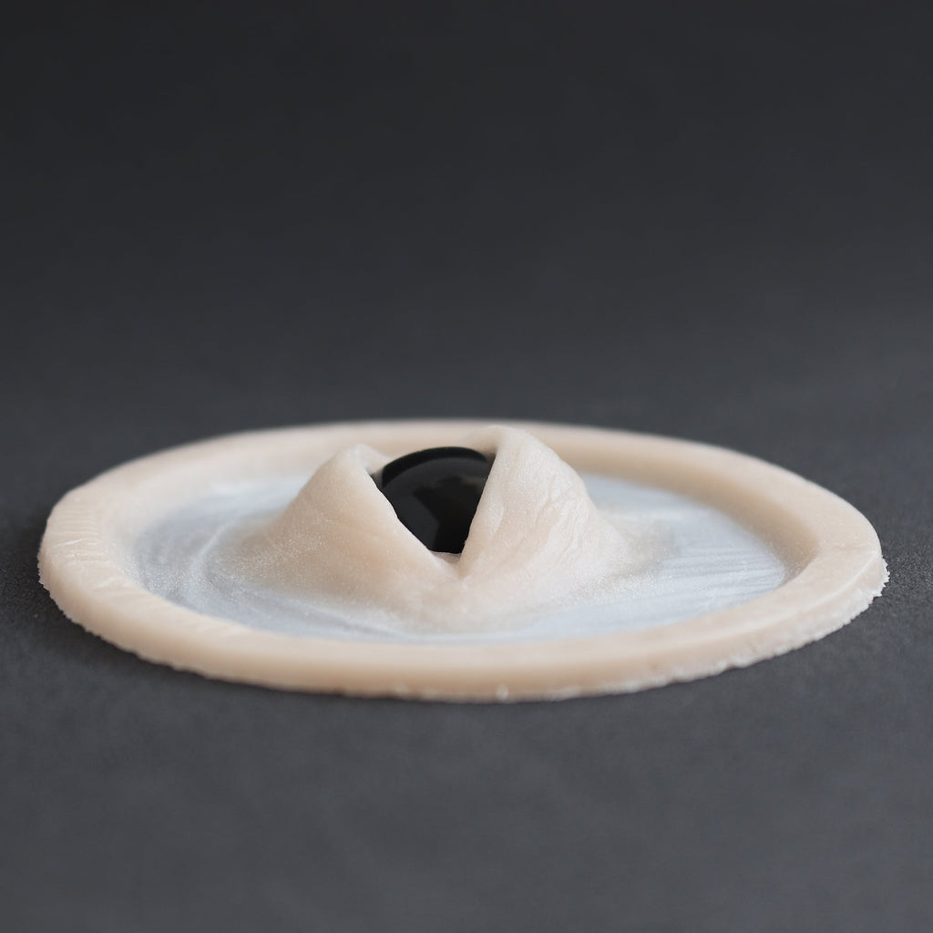 Third Eye - Silicone makeup prosthetic in vanilla shade on a black surface