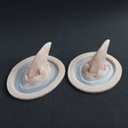 Torn Horns (Pair) - Silicone makeup prosthetic in vanilla shade on a black surface